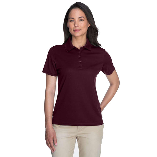 Woman wearing a maroon polo shirt on a white background